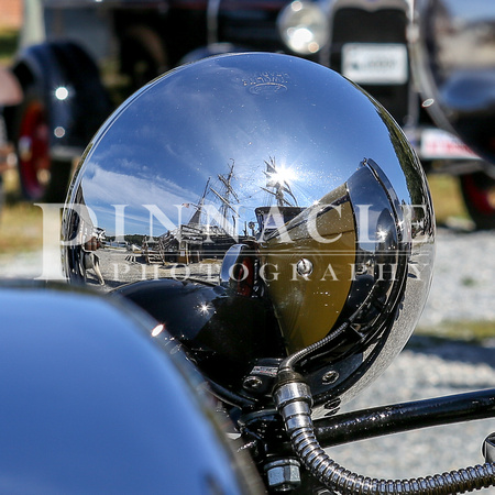 Charles W. Morgan whale ship reflecting in the rear chrome of a headlight from a 1930 Ford Model A